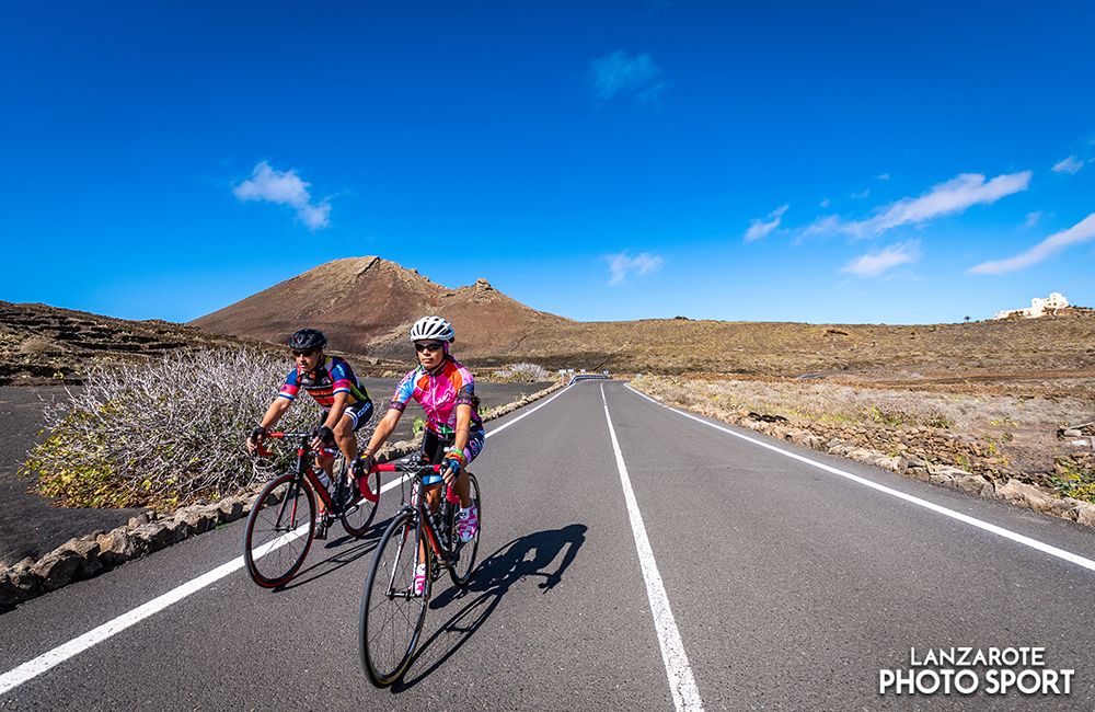 Cyclists descending the road from Corona Volcano