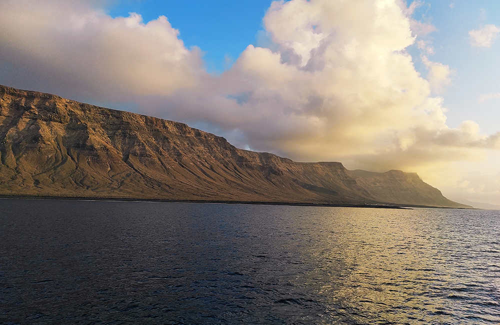 Famara cliff returning by boat from La Graciosa